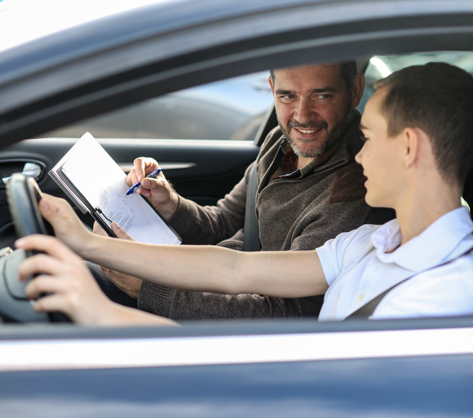Driving lesson with instructor and student driver.