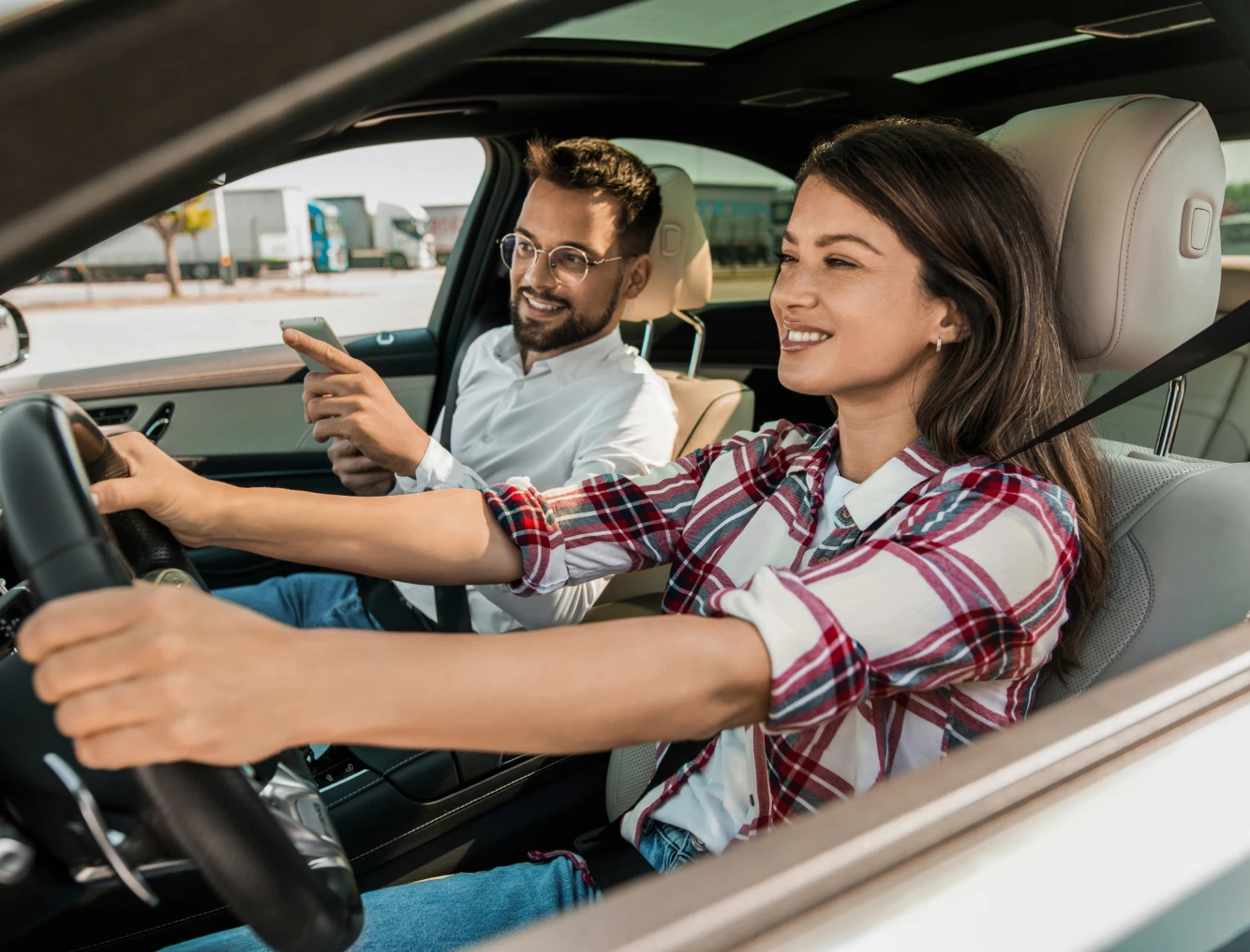 Smiling couple driving in a car together.